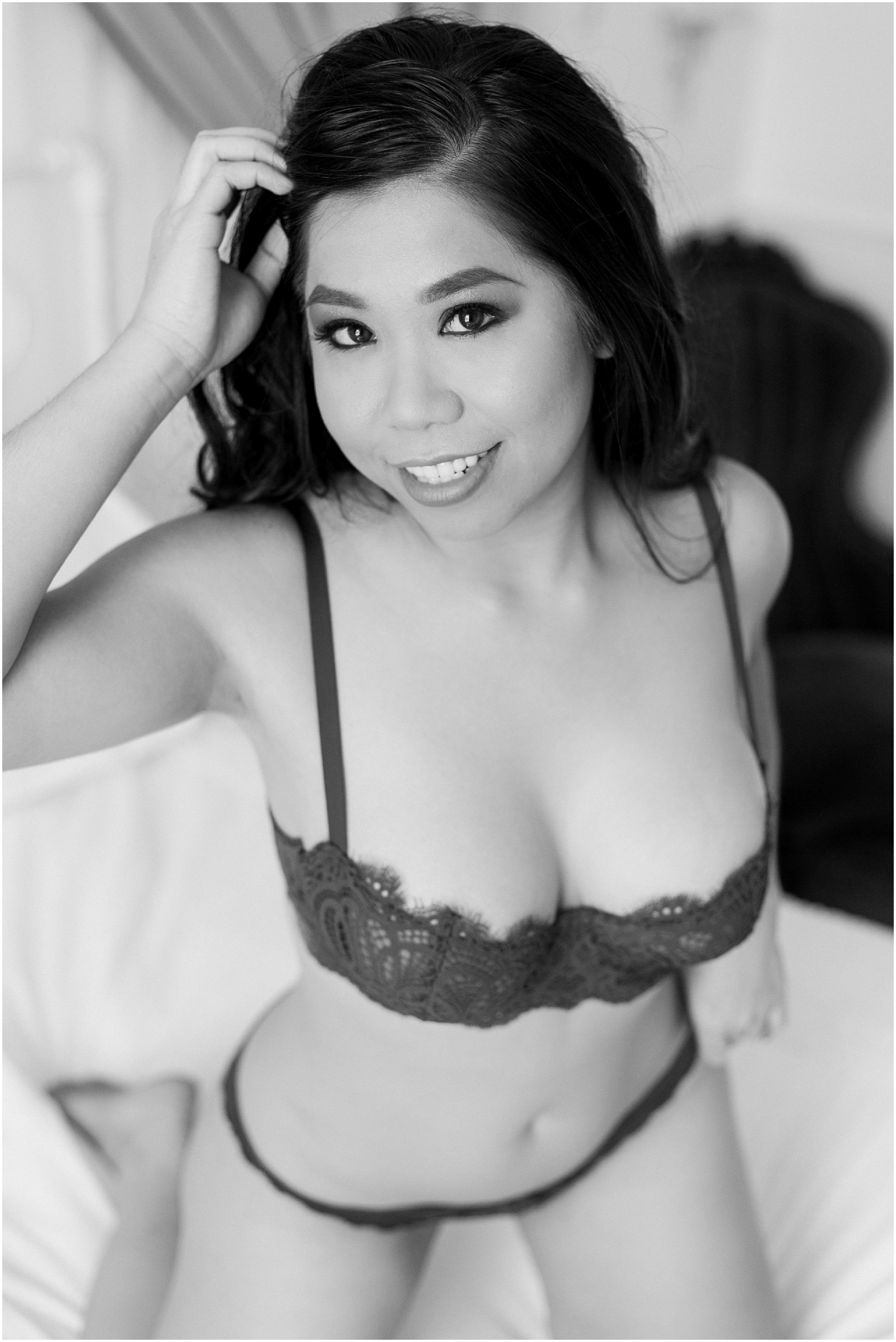 Black and white photo of an Asian model in Victoria's Secret inspired lingerie picks for beauty and boudoir session.