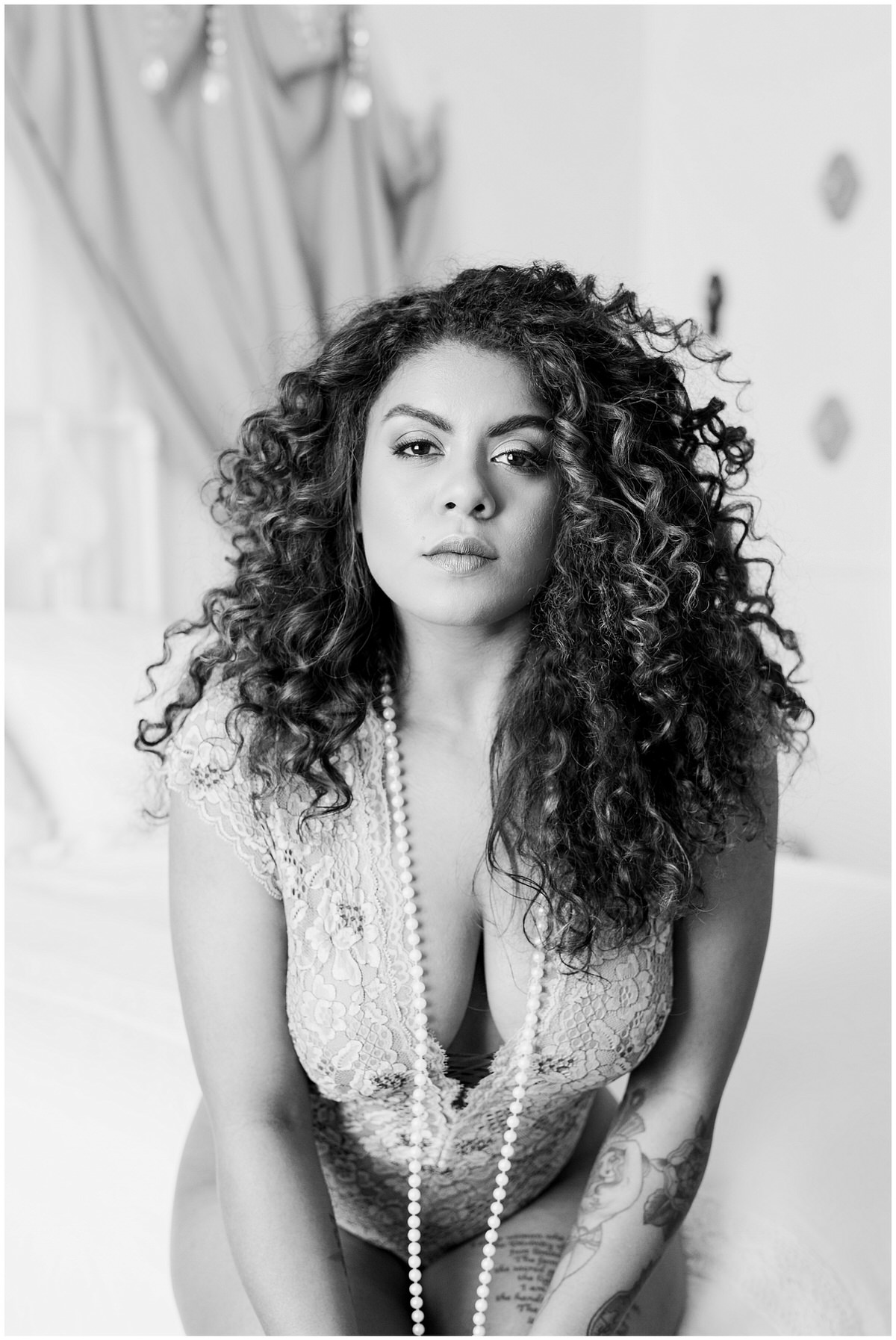 Black and white photo of woman at boudoir session