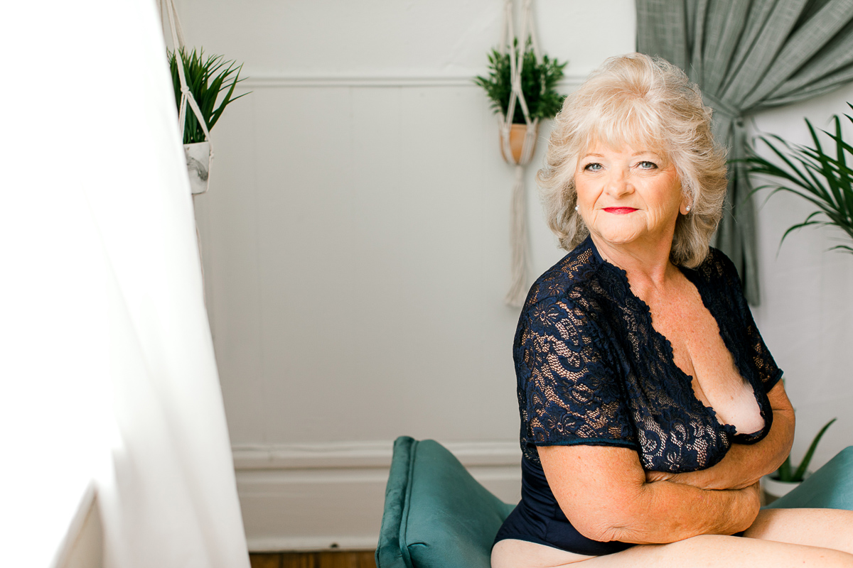 Mature woman posing in boudoir studio