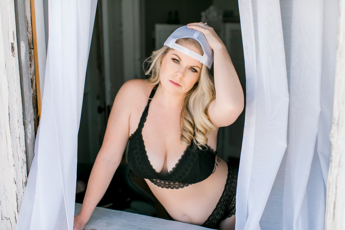 woman wearing mens cap and two piece lingerie