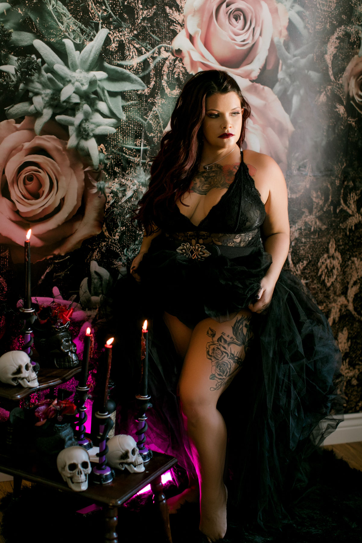 woman on floral wall during halloween boudoir shoot