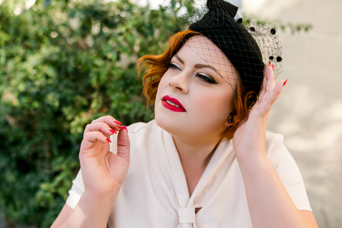 Portrait of 1950's woman in vintage outfit, pillbox hat